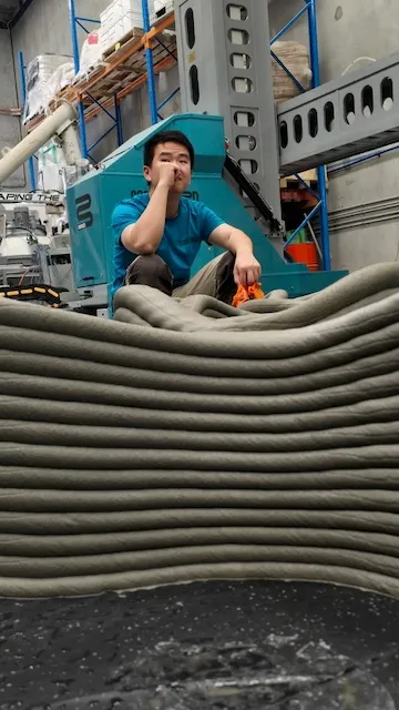 An engineer beside a 3D printed artificial reef structure