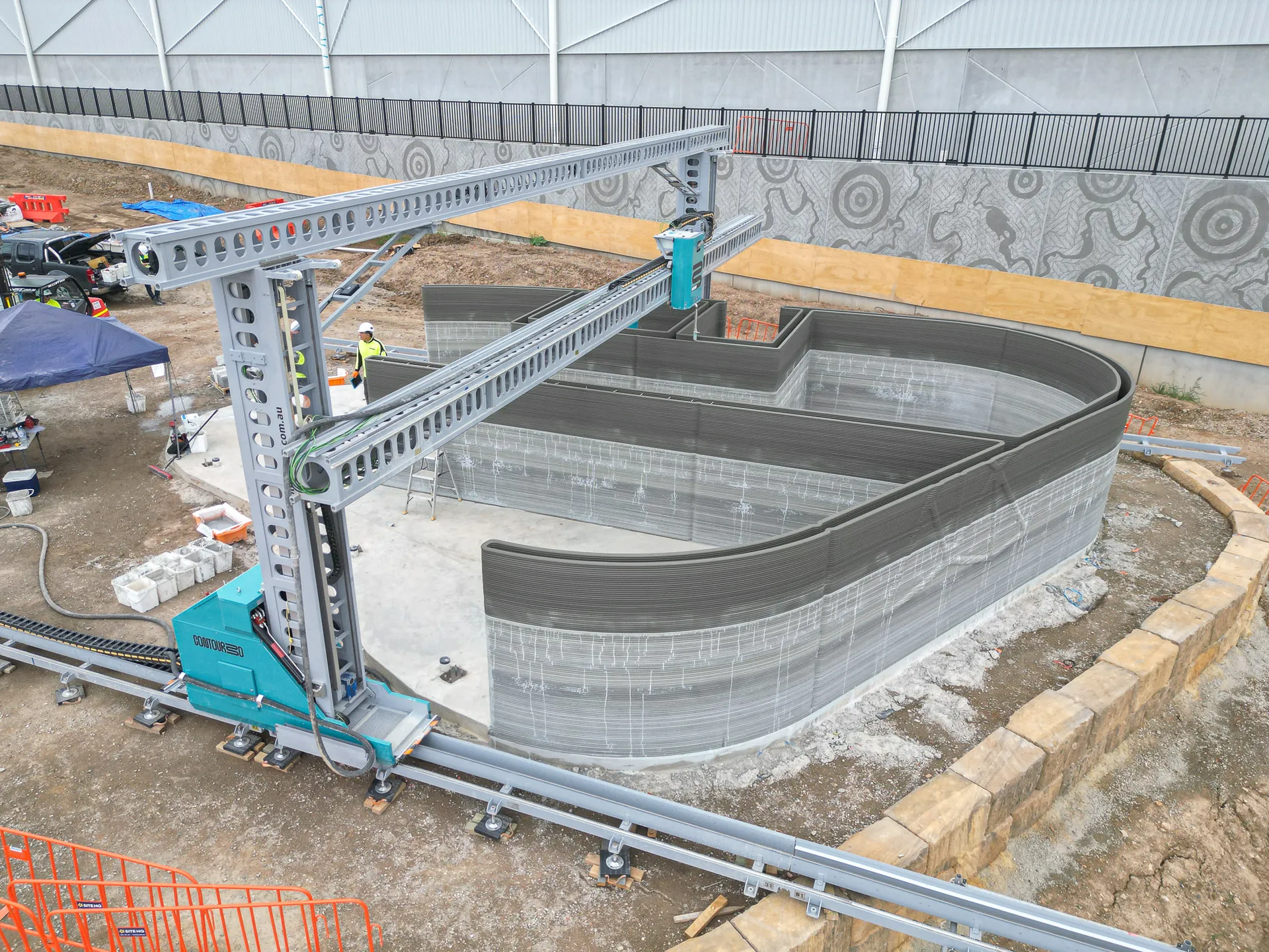 The OPUS 4 gantry printer building curved concrete walls on site