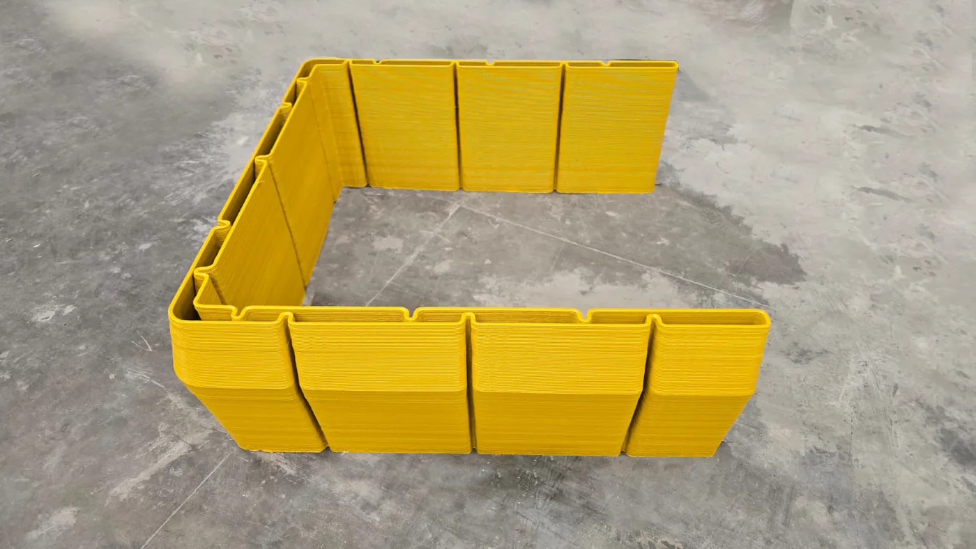 Printed FeatherCrete panels interlocked into a standing enclosure on the Contour3D factory floor