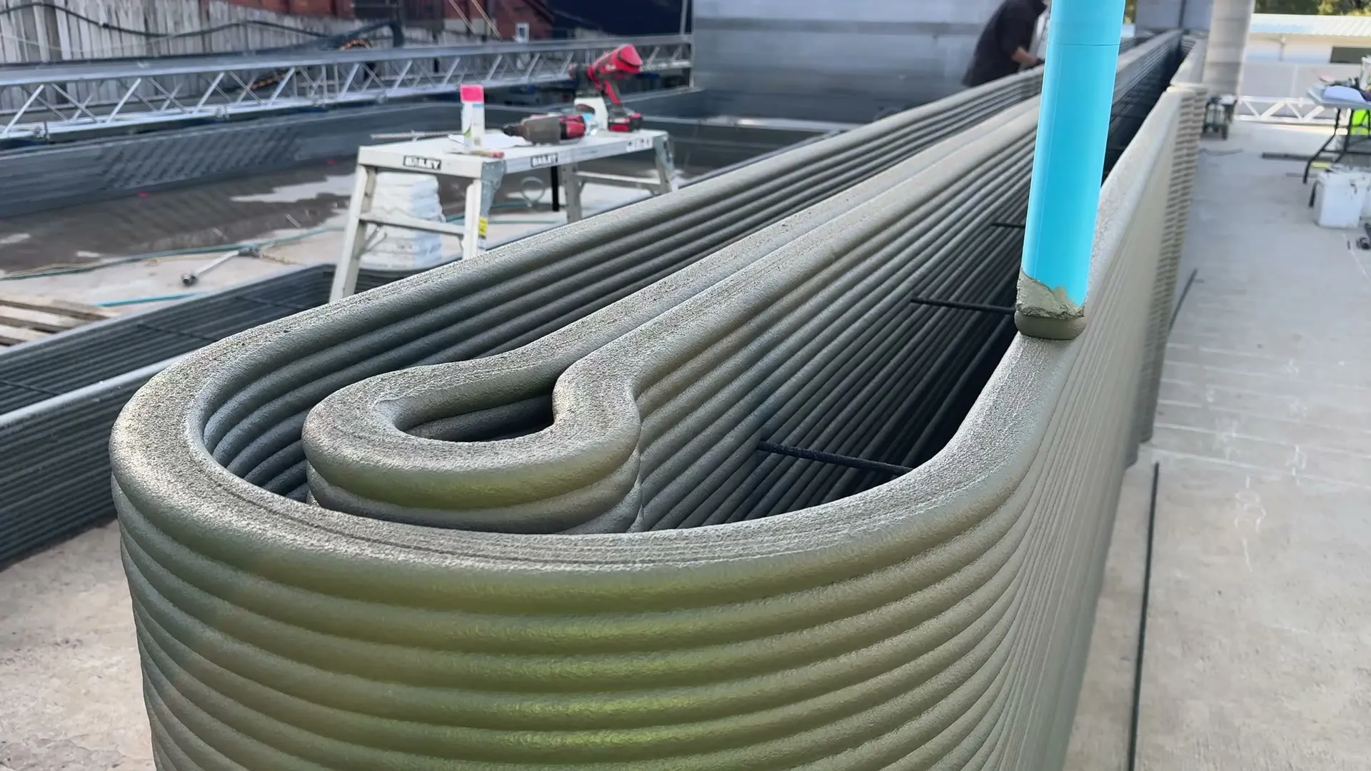 A printed ContourCrete wall on site, layer lines visible